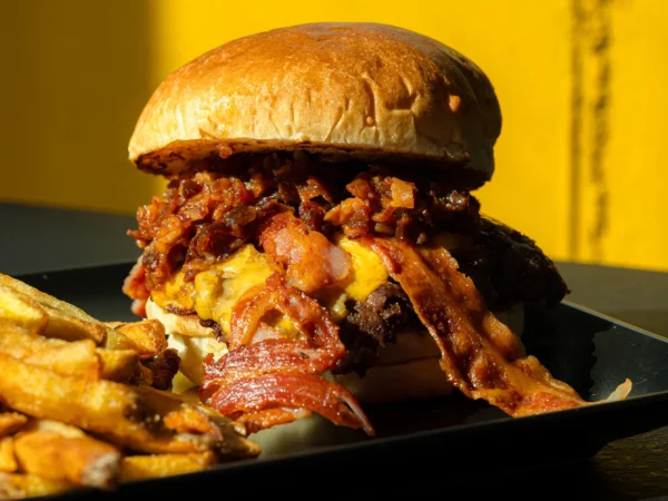 BaconJam smash burger s hranolčekmi, cibuľovými krúžkami a dressingom
